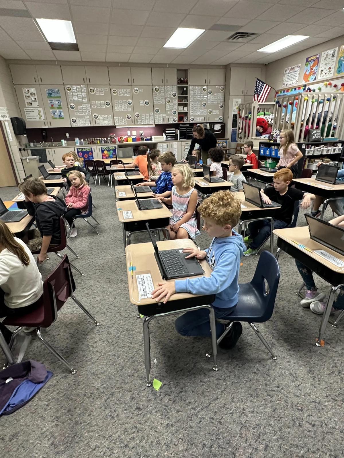 elementary school students learning on computers