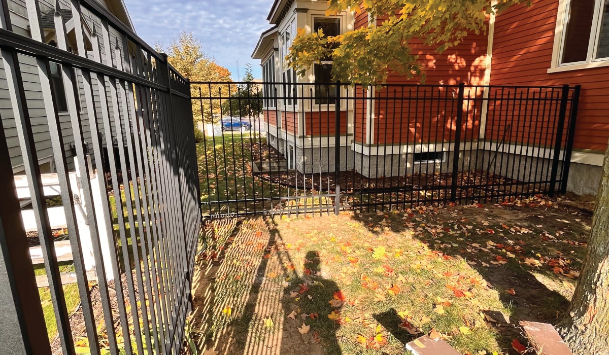 aluminum fence install around red house