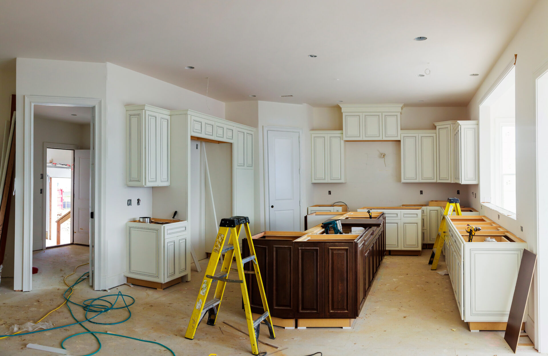 Custom kitchen cabinets in various stages of installation base for island in center