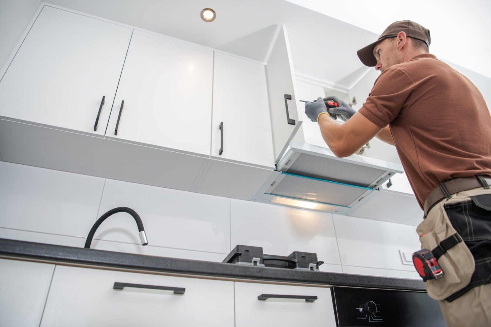 Contractor Worker Assembling of New Apartment Kitchen Cabinets