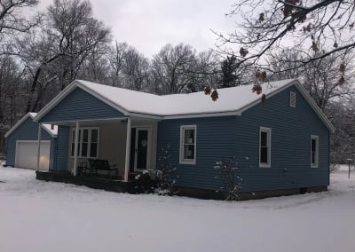 new blue siding on house and garage other side