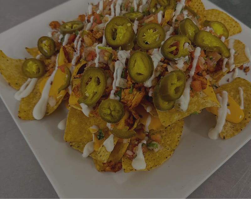 a plate of loaded nachos