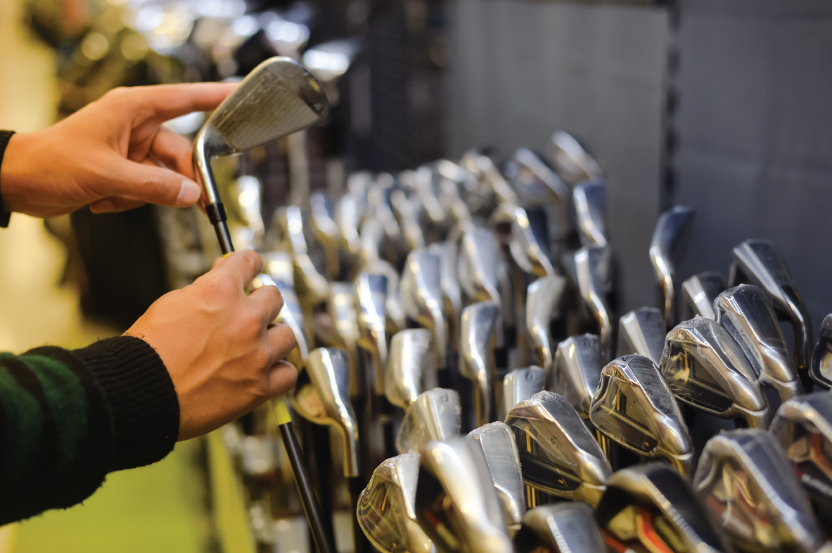 customer looking at variety of golf clubs